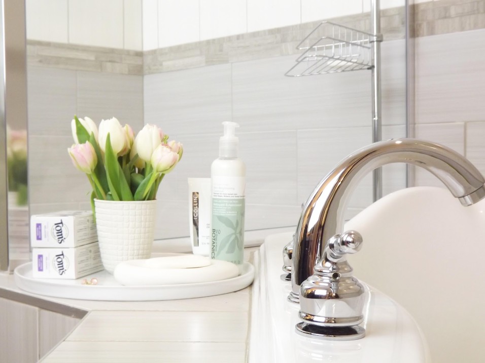 bathroom-decorations-scenic-stainless-steel-unique-mixer-taps-on-white-porcelain-washbasin-with-white-tulips-flowers-vase-and-liquid-soap-as-well-as-sweet-grey-wall-tiles-bath-and-free-standing-