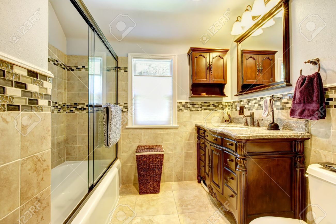 14615038-Classic-bathroom-with-natural-stone-tiles-and-wood-cabinet--Stock-Photo