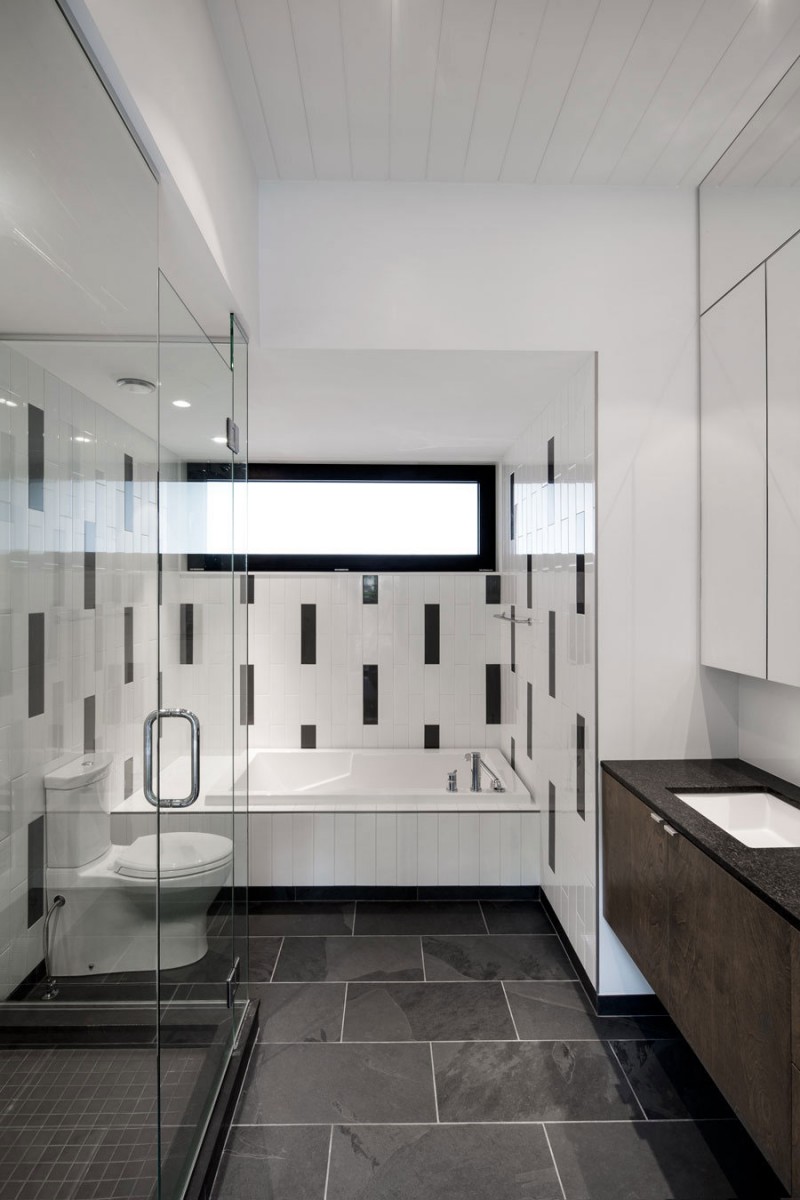 bathroom-interior-elegant-white-tiles-for-tub-surround-in-the-contempo-bathroom-design-glass-stall-shower-white-toilet-white-square-bathtub-brown-vanity-black-countertop-black-natural-stone-floor-c