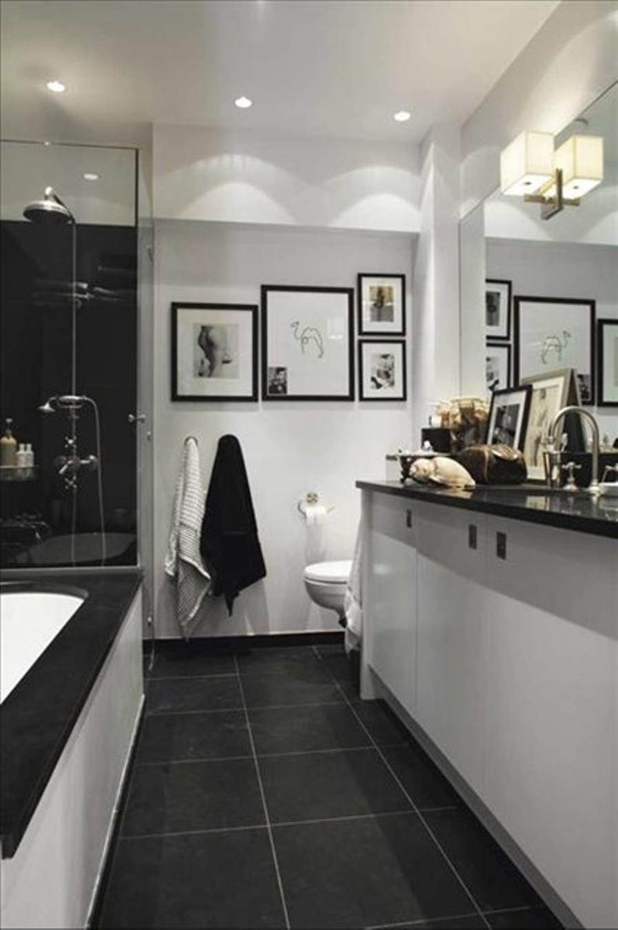 bathroom-with-dark-floor-tiles-and-white-walls-and-recessed-bathroom-lighting-fixtures-in-the-ceiling-with-black-and-white-sink-vanity