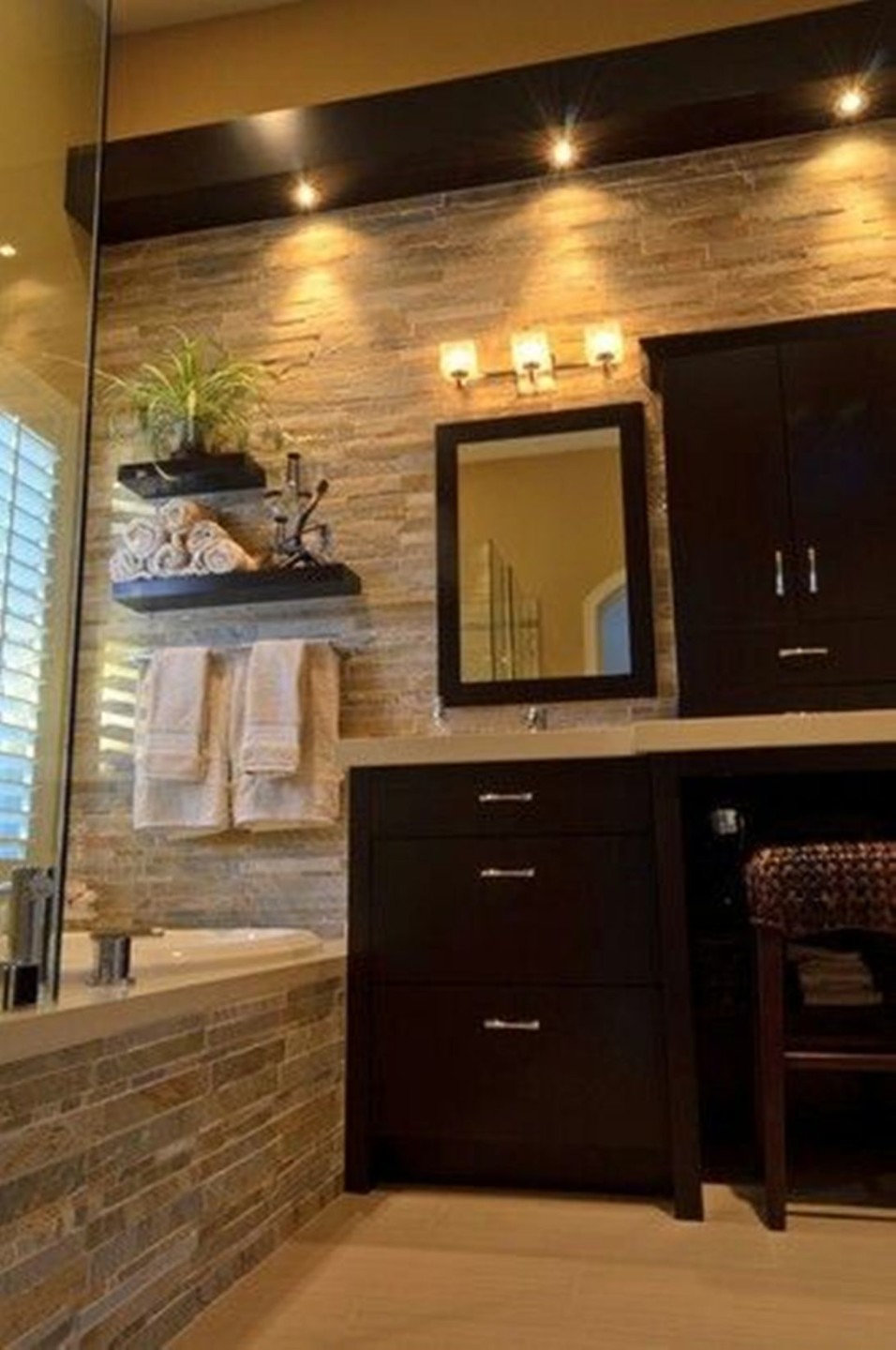 cool-bathroom-with-natural-stone-bathroom-tiles-and-dark-wood-vanity-and-recessed-bathroom-lighting-fixtures