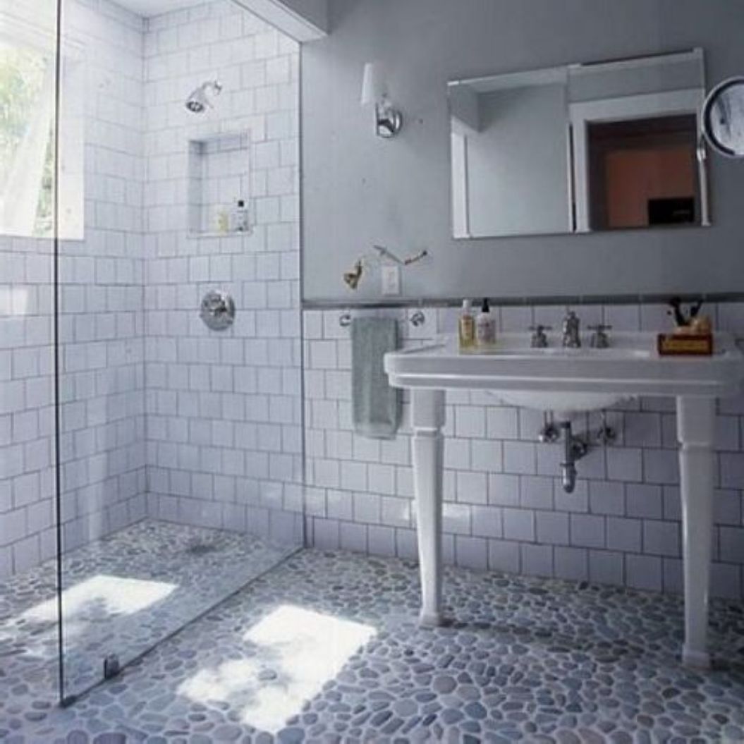 old-style-subway-tile-bathroom-in-shower-with-modern-glass-door-and-wall-and-pebble-floor