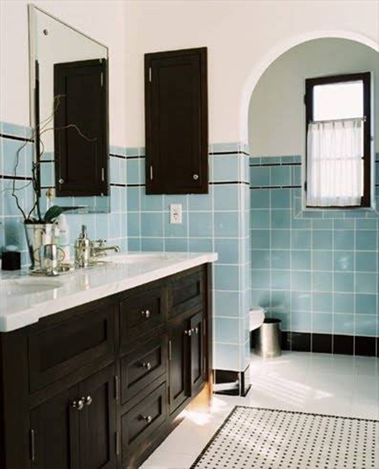 retro-bathroom-with-blue-and-black-tiles-and-wooden-vanity