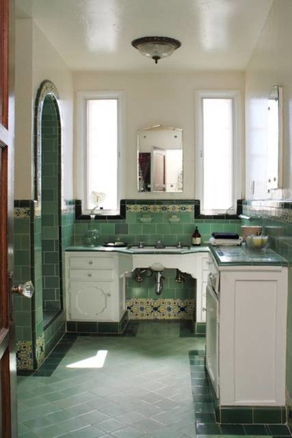 retro-bathroom-with-green-tiles-and-whote-vanity-cabinets