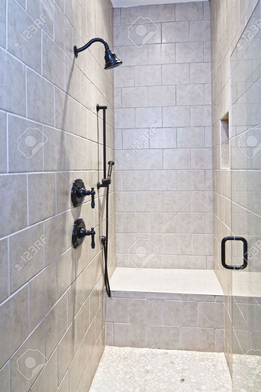 6341908-luxury-shower-with-bench-and-pebble-floor-Stock-Photo-shower-bathroom-tile