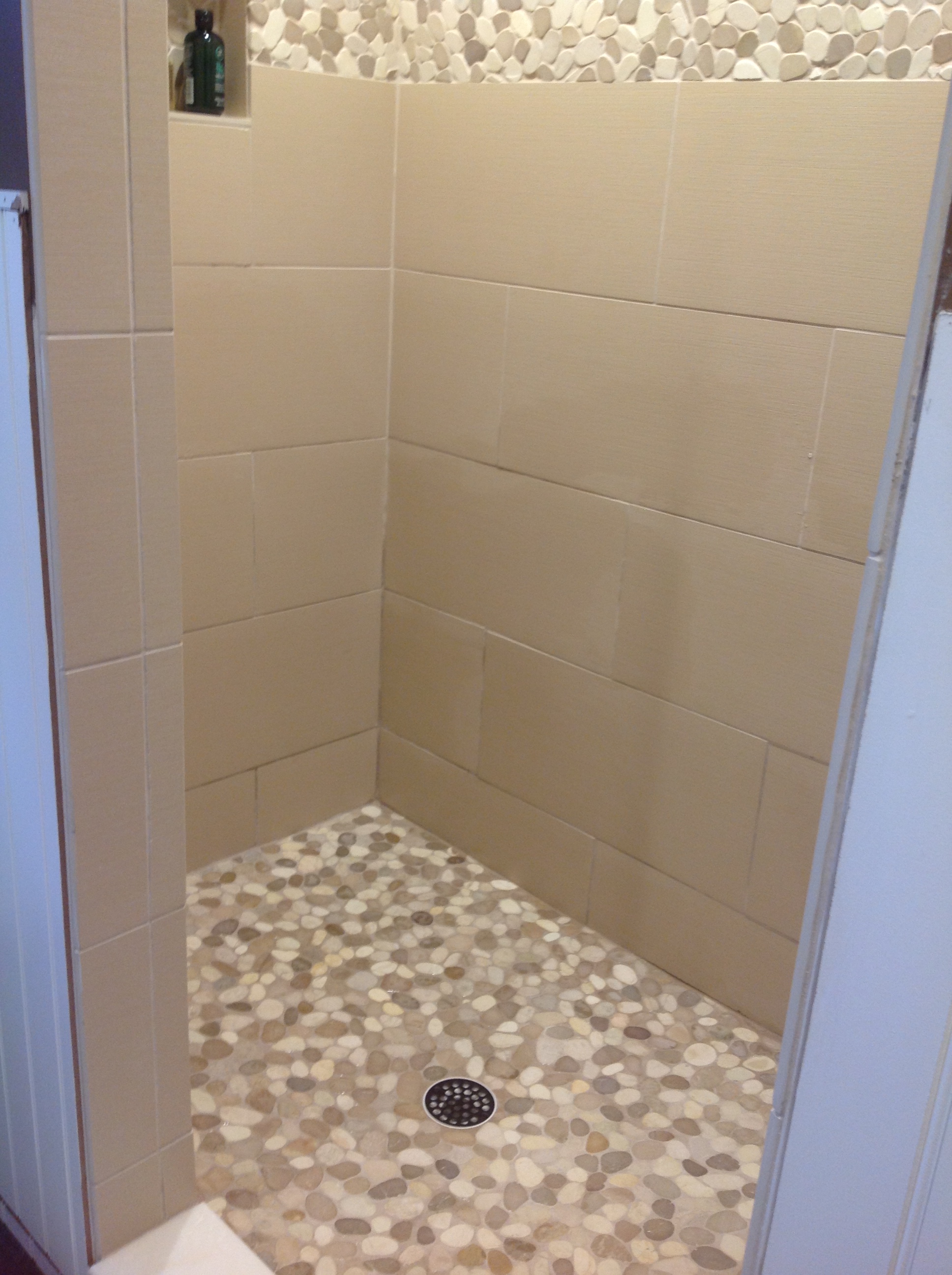 Sliced-Tan-and-White-Pebble-Tile-Shower-Flooring