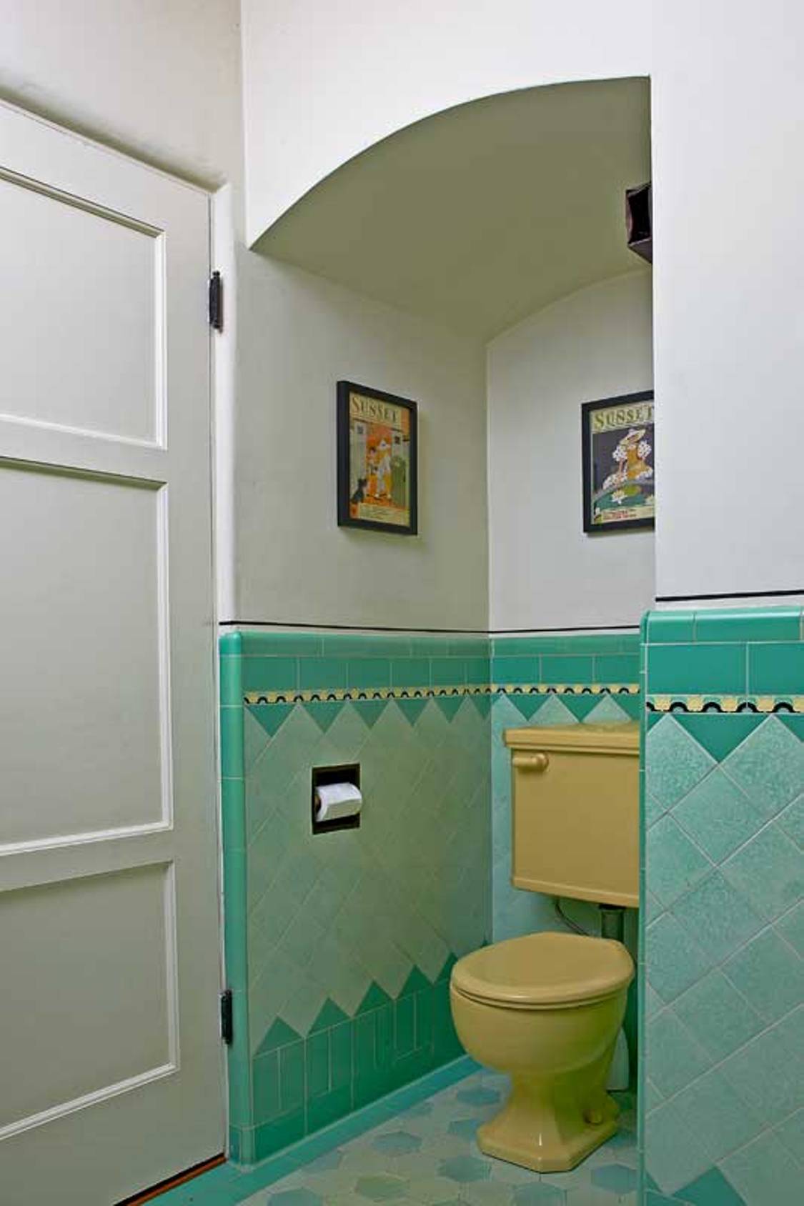 art-deco-bathroom-with-old-yellow-toilet-and-blue-tiles