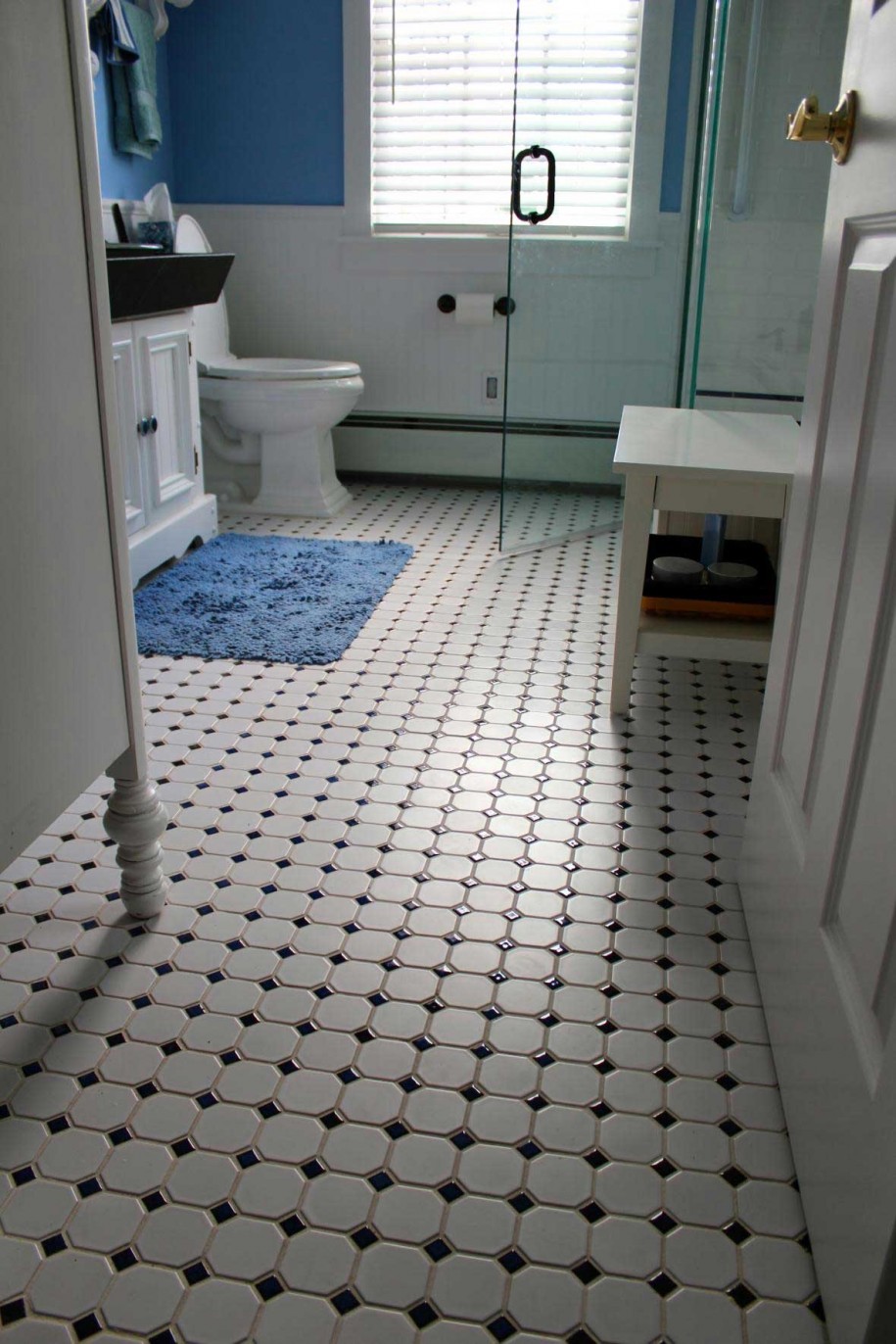 astonishing-bathroom-design-featuring-glass-shower-room-and-white-toilet-also-painted-white-bath-vanity-plus-white-bench-with-vintage-tiles-floor-pattern-and-blue-mattress-decor-vintage-bathroom-tile