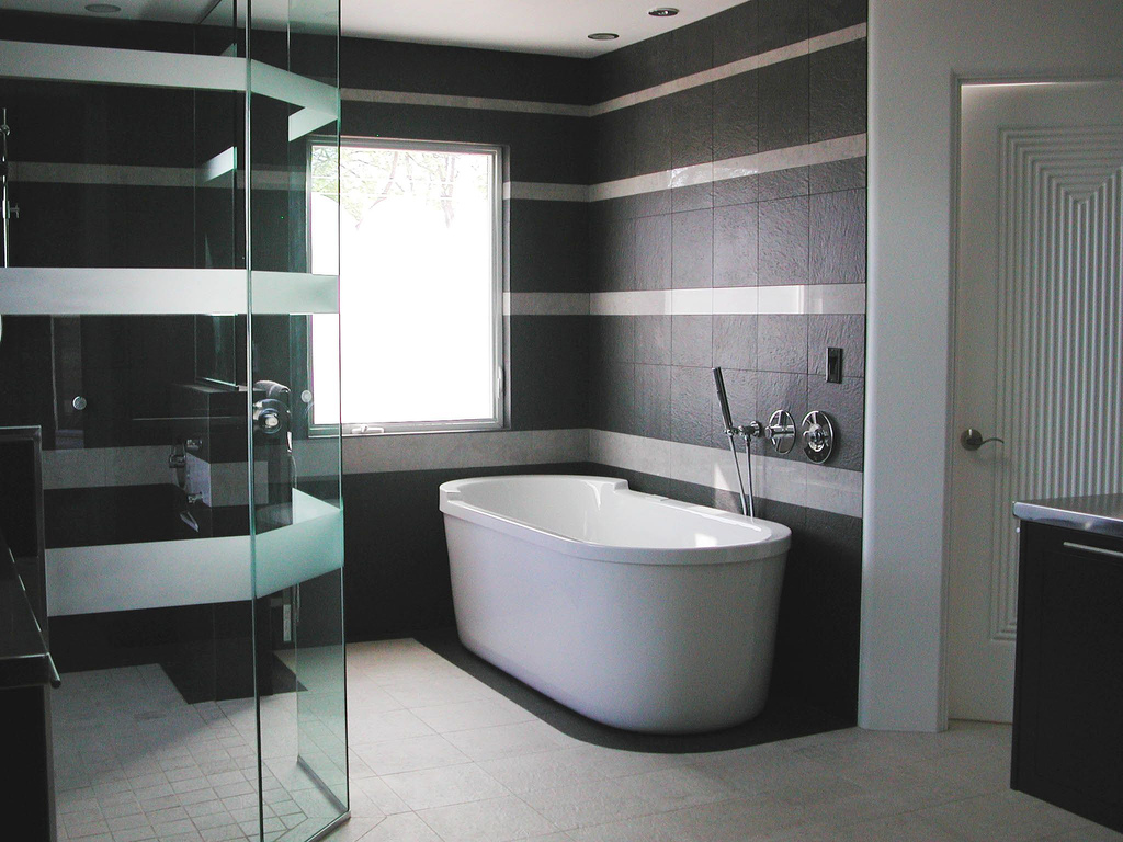 bathroom-elegant-black-and-white-bathroom-decoration-using-clear-glass-shower-door-including-black-high-end-bathroom-tile-and-oval-white-ceramic-free-standing-bathtub-interactive-high-end-tile-bathro