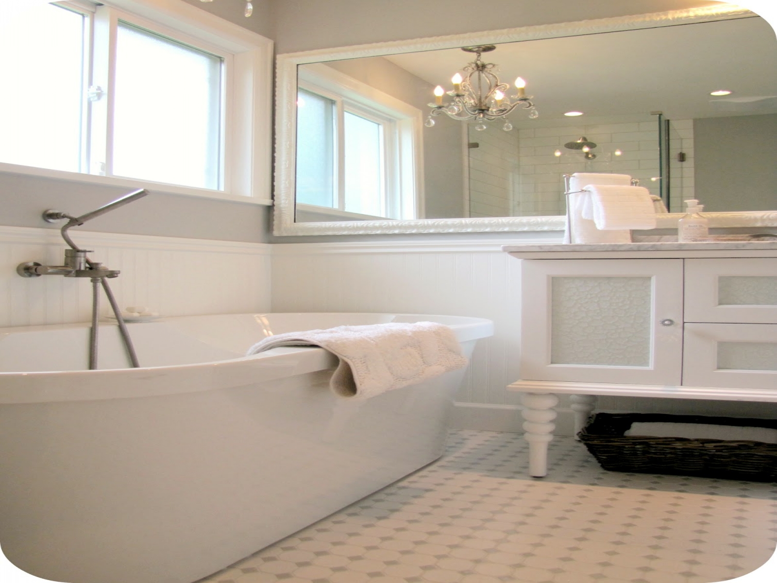 ceramic-flooring-tile-white-standalone-bathtub-glass-window-panel-mirror-with-wooden-frame-small-real-wood-vanity-new-construction-farmhouse-with-bathroom-chandeliers