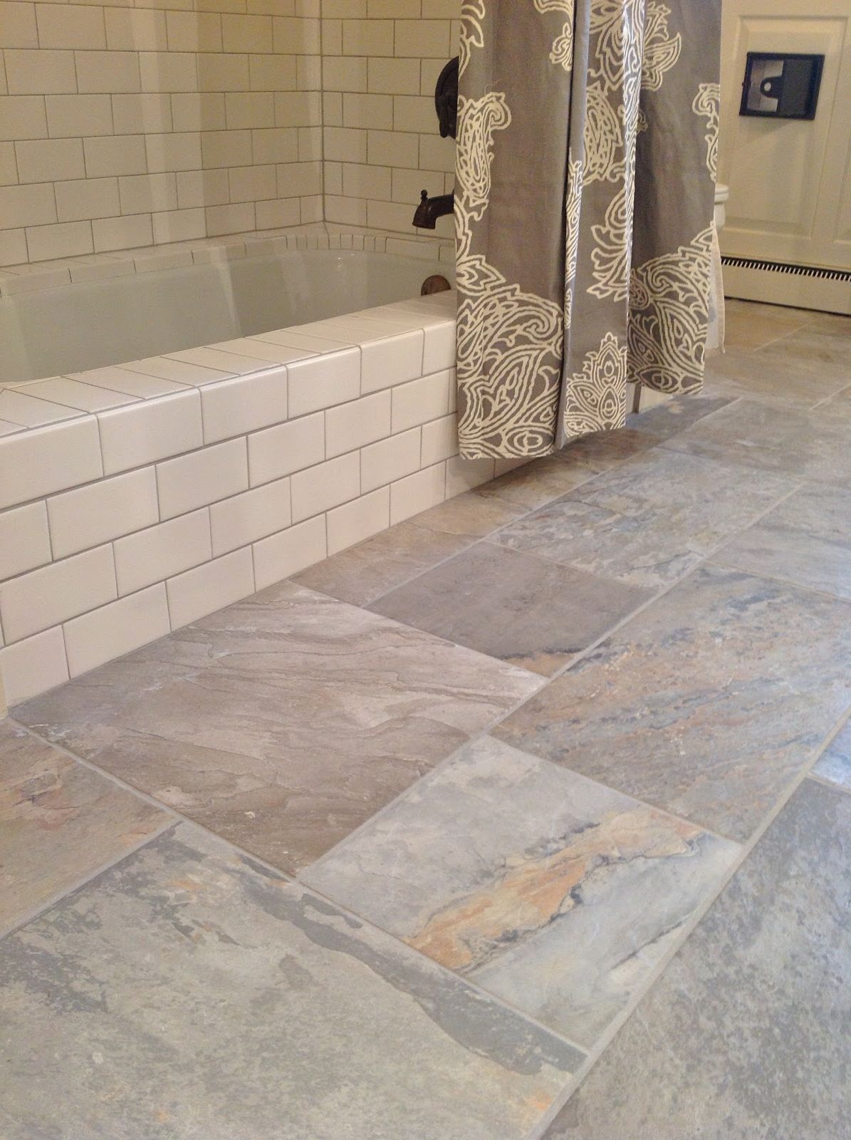 farmhouse-bathroom-design-with-natural-ceramic-floor-and-white-bathtub-tiles