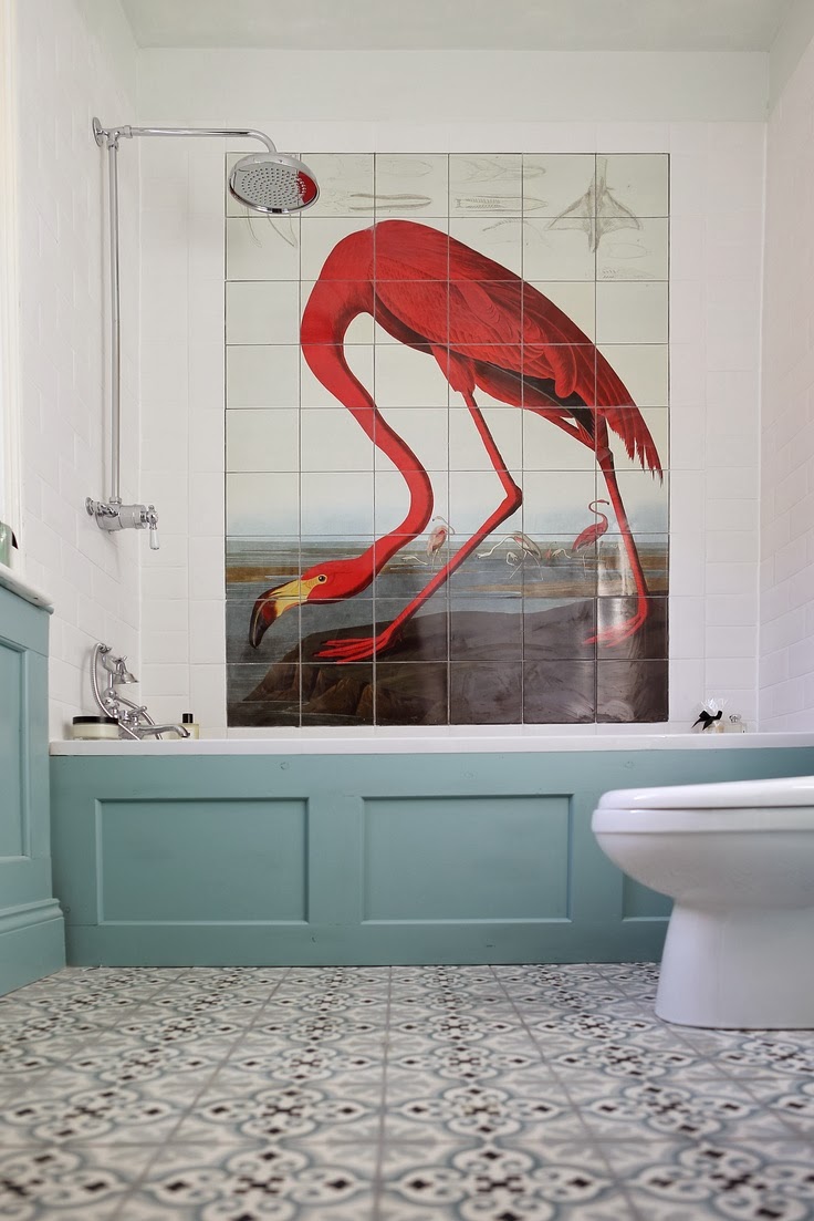 red flamingo wall tiles in white bathroom with blue wanescotting and decorative floor tiles